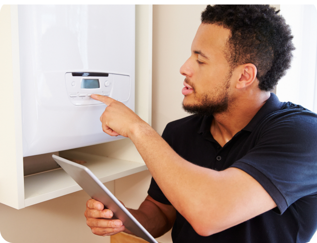 Property manager inspecting a gas geyser after a maintenance issue was logged through the Sorto system.